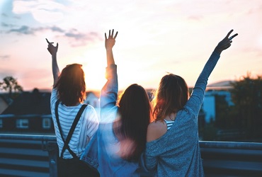 IWCE Friendship - Three women lifting their hands - Photo by Simon Maage on Unsplash